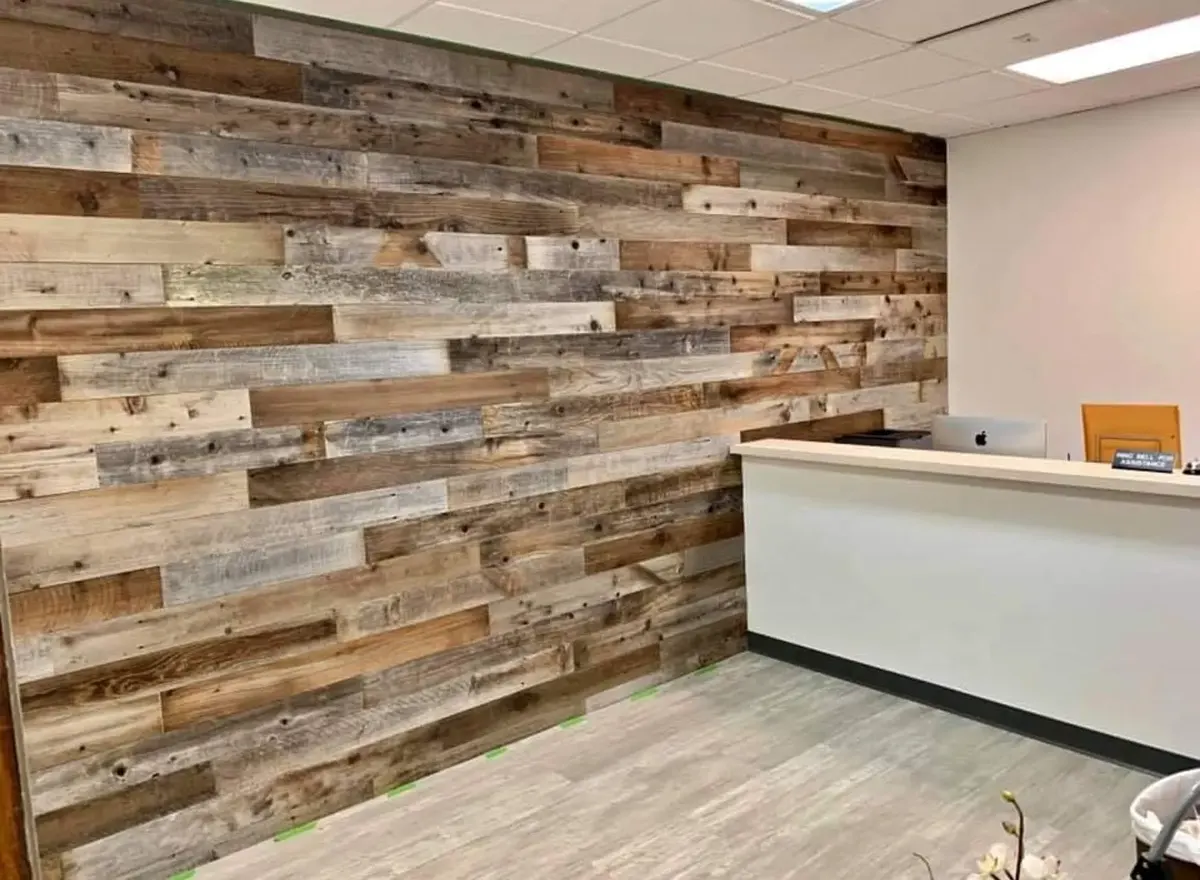 Finished office interior with a broad reclaimed-wood feature wall