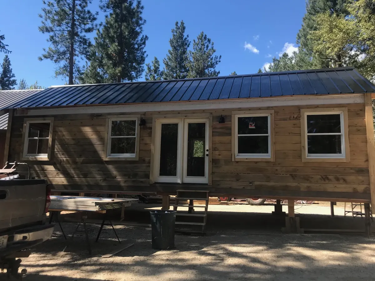 Compact cabin exterior finished with natural wood siding